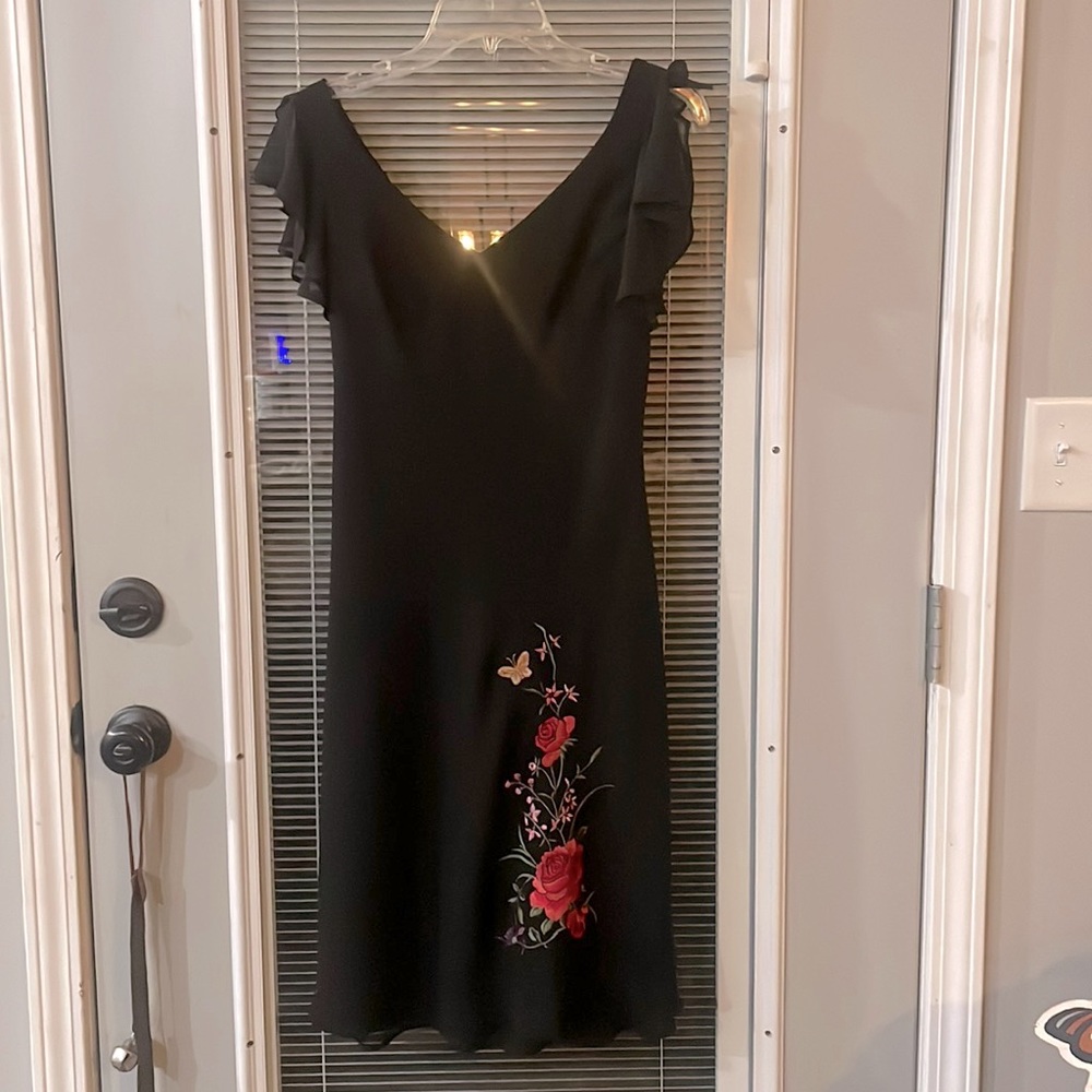 Black dress with beautiful flower stitching, & ruffle sleeves. Size 6.